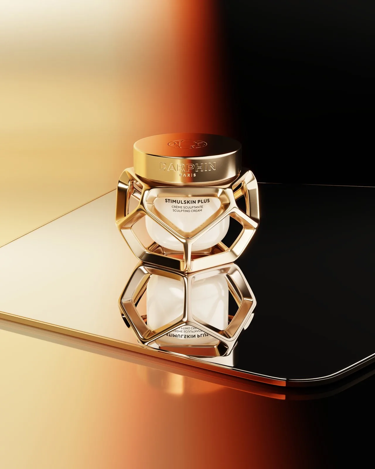 Darphin Stimulskin Plus — gold jars on mirrored surface, angle 1