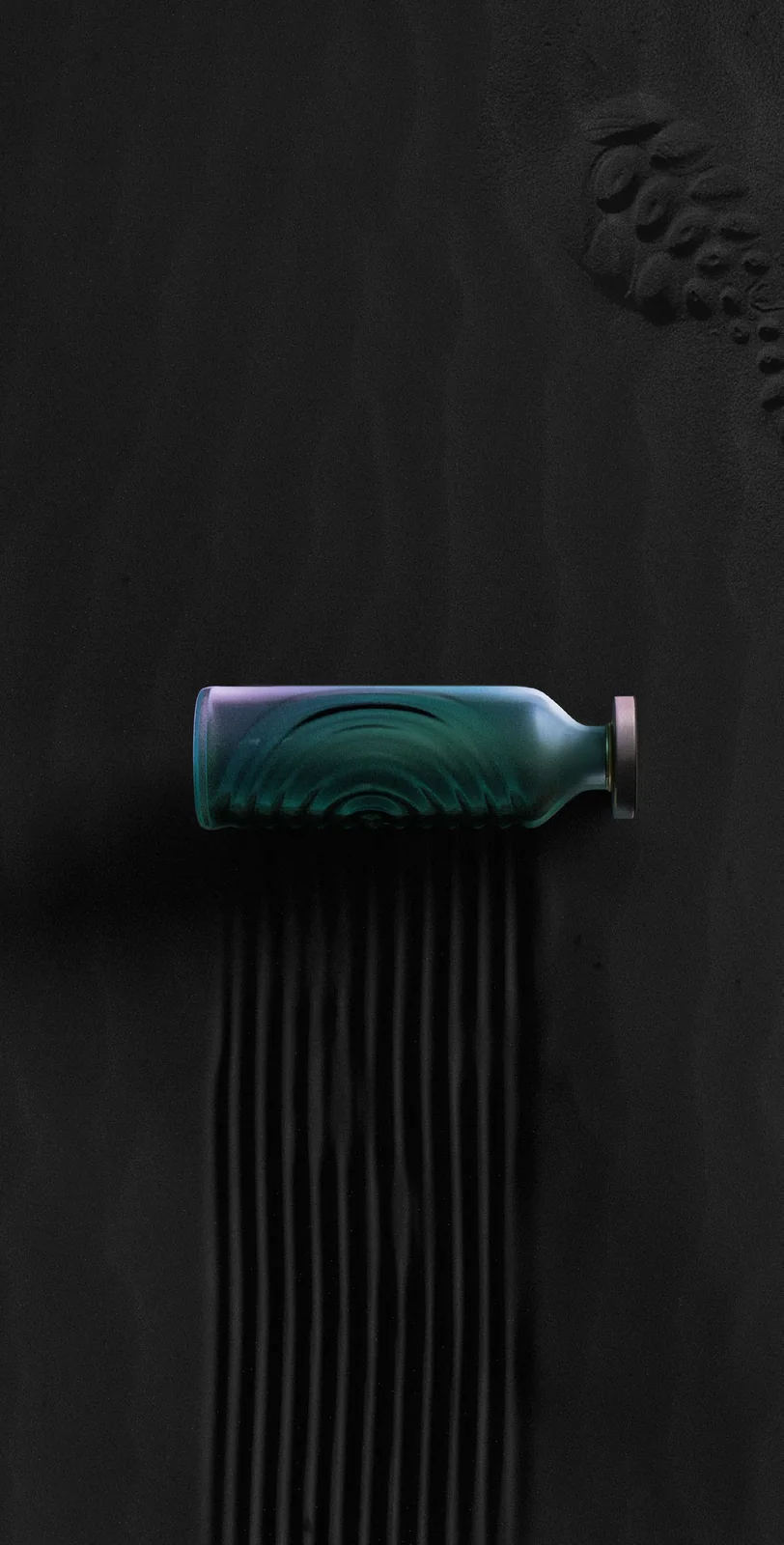 Verallia Design Awards T Bottle — lying on dark sand, drag marks